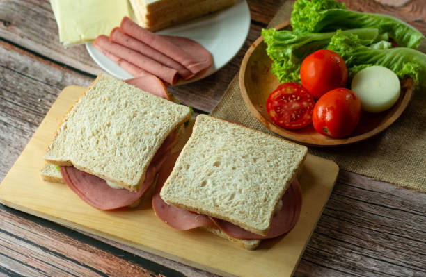 closeup honey ham wheat bread sandwich in white background