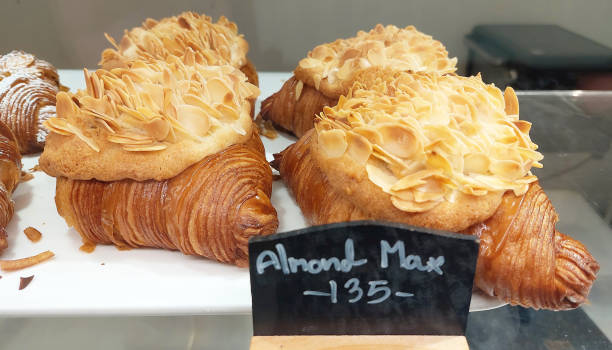 istock Croissants topped with crunchy almonds on display in the bakery. 2154846382