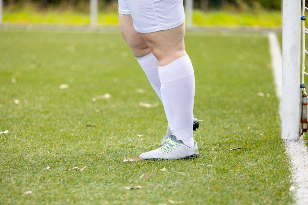 istock Soccer player standing on a grass field 2154847604