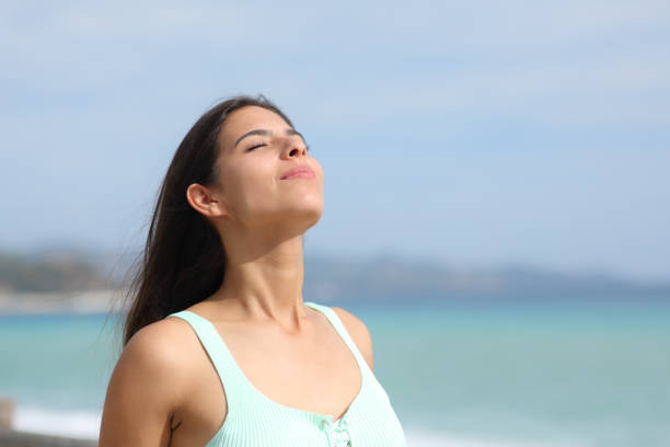 istock Casual woman is breathing on the beach 2154848148