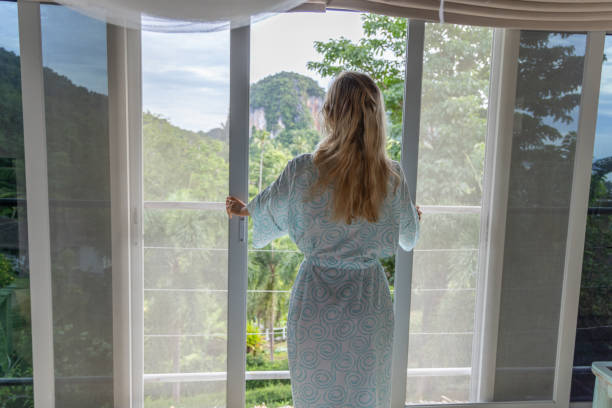 istock Woman stepping onto a balcony 2154848944