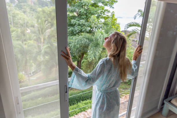 Woman on vacation enjoying nature from a balcony