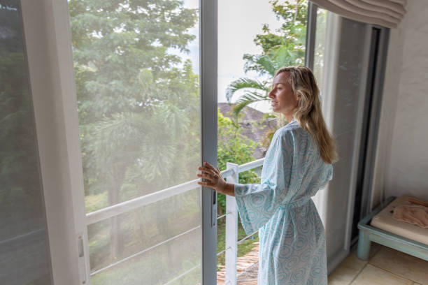 istock Happy woman enjoying a beautiful view from her balcony 2154848948