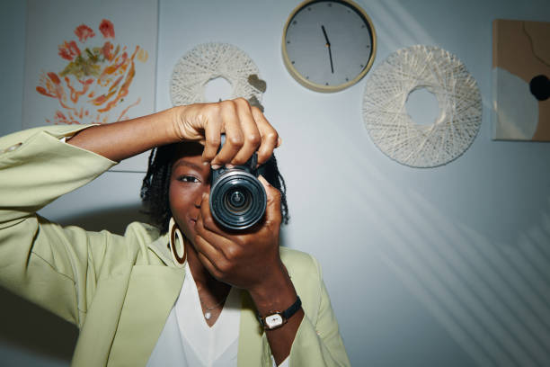 Creative young woman enjoying taking photos