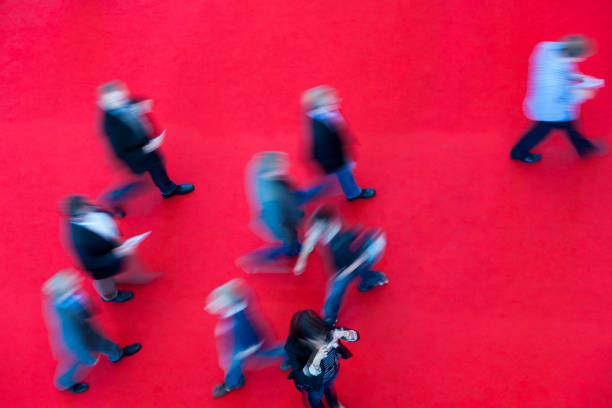 istock Crowd of Blurred People Walking Fast on Red Carpet 2154850972