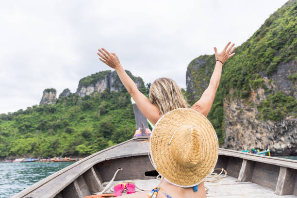 istock Woman Celebrating on Boat in Tropical Waters 2154851946