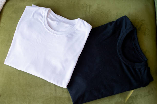 istock A black and white T-shirt lies folded on the table 2154854401