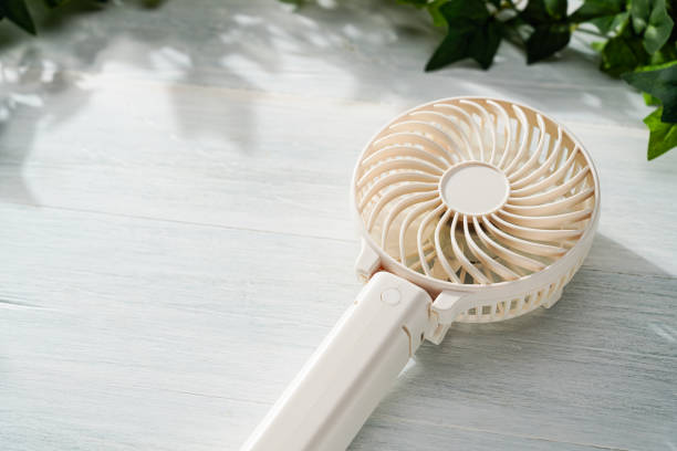istock Portable electric fan on wooden table 2154854865