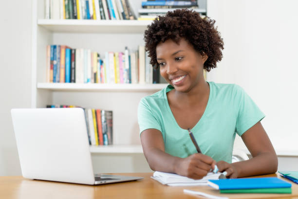 istock Motivated african american female student learning for graduation at library 2154854876