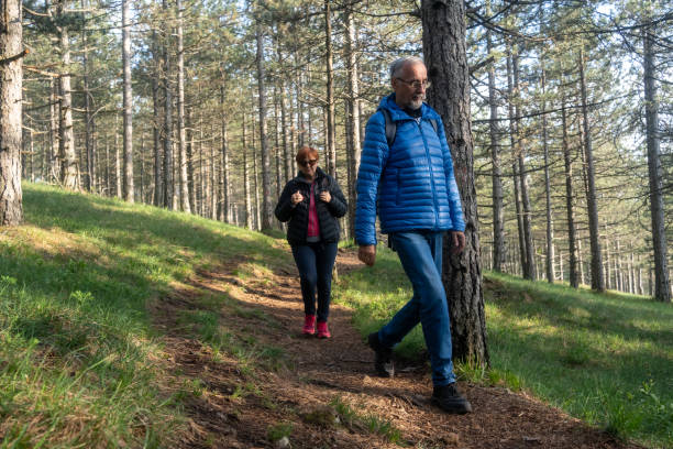 istock Active retired couple hiking in forest 2154854935