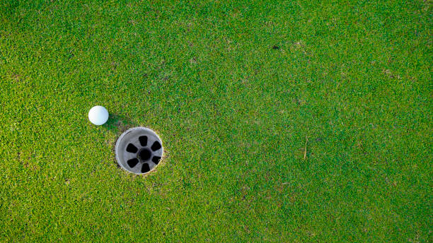 istock Golf ball on green grass in the evening golf course with sunshine background. 2154856072