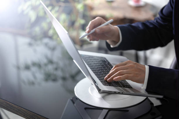 istock Businessman working on laptop computer at office desk 2154856596