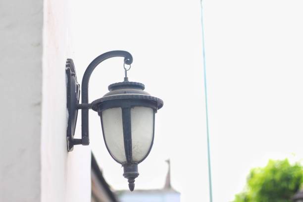 old outdoor wall lamp on white exterior