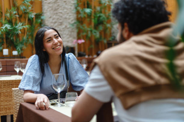 istock Smiling Hispanic Woman Dining with a Friend 2154858767