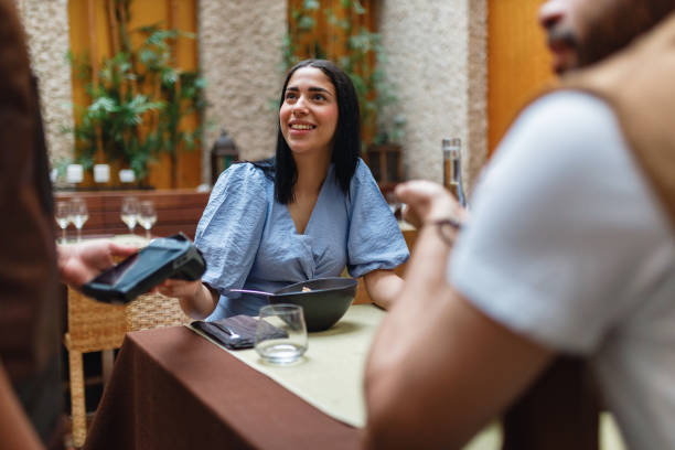 istock Young Friends Dining and Socializing in Restaurant 2154858819