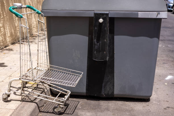 istock a supermarket cart in a garbage 2154858892