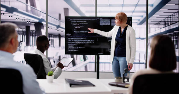 istock Programmer Team Meeting With TV Screen In Office 2154859682
