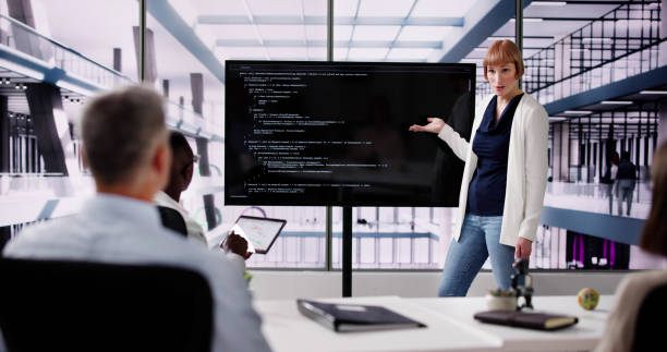 istock Programmer Team Meeting With TV Screen In Office 2154859740