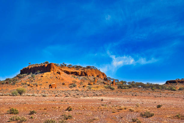 Uluru, Australia - August 22, 2016: Sunrise over Uluru, the famous giant monolith in the Australian desert. Image taken from the approved public viewing and photography area.