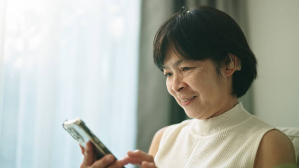 istock Deaf woman using smartphone at home. 2154863359