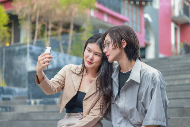 istock Asian couples playfully bond, sharing affectionate gazes, laughter, and intimate warmth outdoors. 2154864945