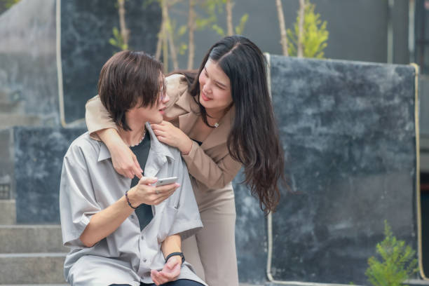 istock Asian couples playfully bond, sharing affectionate gazes, laughter, and intimate warmth outdoors. 2154865011