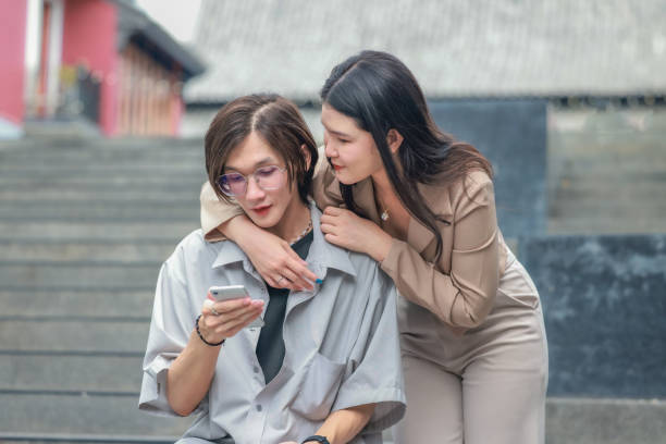 istock Asian couples playfully bond, sharing affectionate gazes, laughter, and intimate warmth outdoors. 2154865430