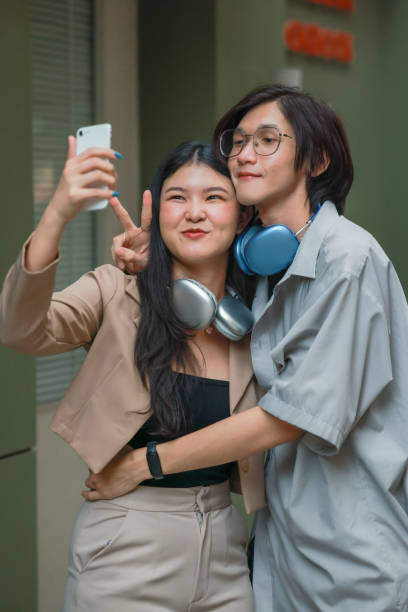 istock Asian couples playfully bond, sharing affectionate gazes, laughter, and intimate warmth outdoors. 2154866225