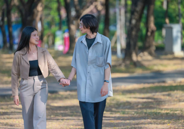 istock Asian couples playfully bond, sharing affectionate gazes, laughter, and intimate warmth outdoors. 2154866968