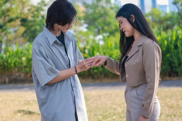 istock Asian couples playfully bond, sharing affectionate gazes, laughter, and intimate warmth outdoors. 2154866969