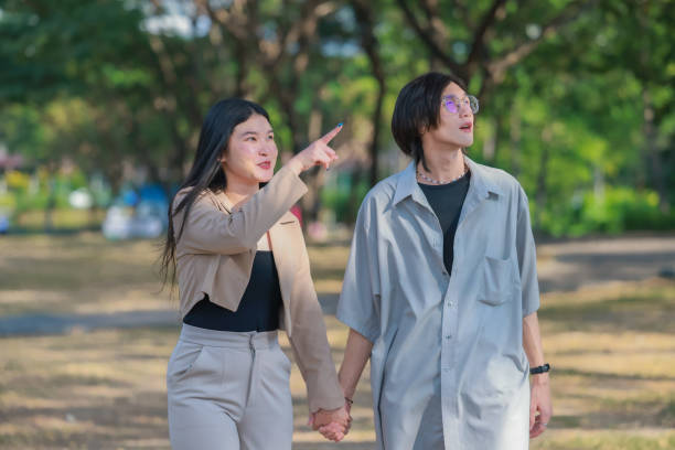istock Asian couples playfully bond, sharing affectionate gazes, laughter, and intimate warmth outdoors. 2154867017