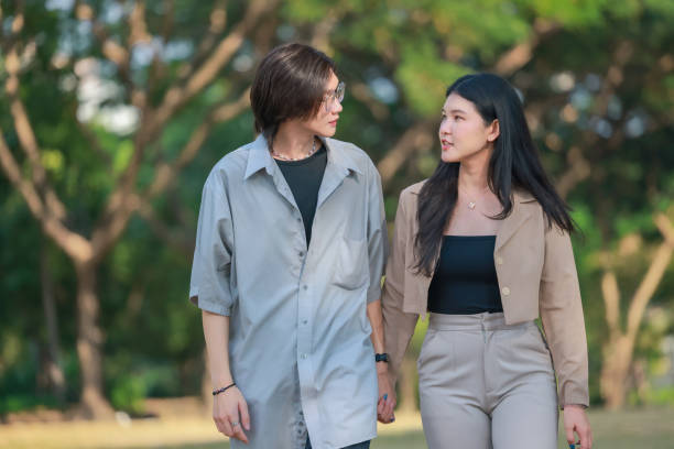 istock Asian couples playfully bond, sharing affectionate gazes, laughter, and intimate warmth outdoors. 2154867033