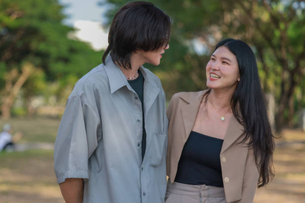 istock Asian couples playfully bond, sharing affectionate gazes, laughter, and intimate warmth outdoors. 2154867075