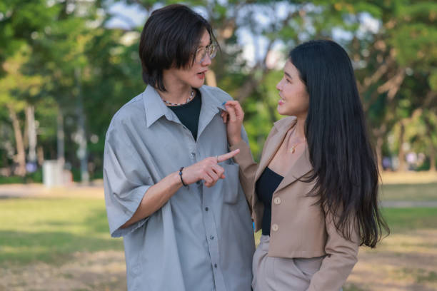 istock Asian couples playfully bond, sharing affectionate gazes, laughter, and intimate warmth outdoors. 2154867077