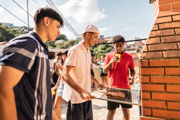 istock Friends preparing barbecue during rooftop house party 2154867782