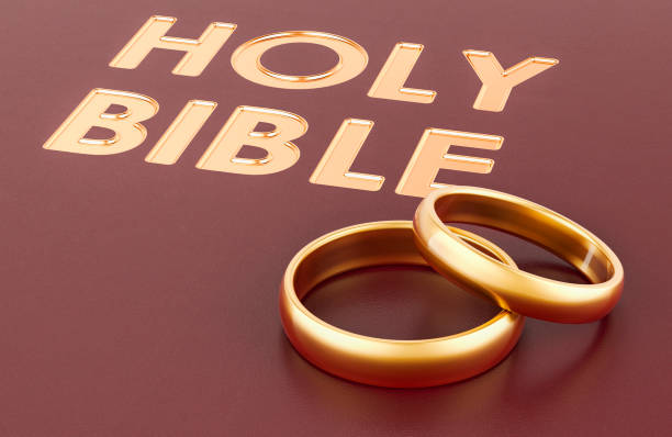 Bible with golden wedding rings, 3D rendering
