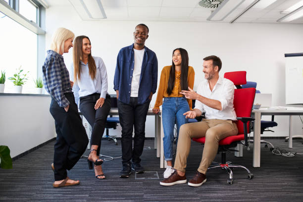 istock Diverse group of colleagues at office work having casual conversation 2154868552