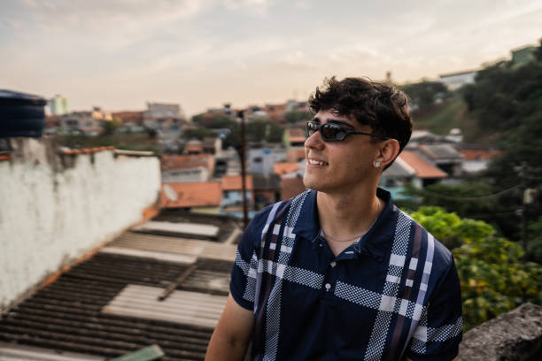 istock Young man looking away contemplating in favela on Brazil 2154868773