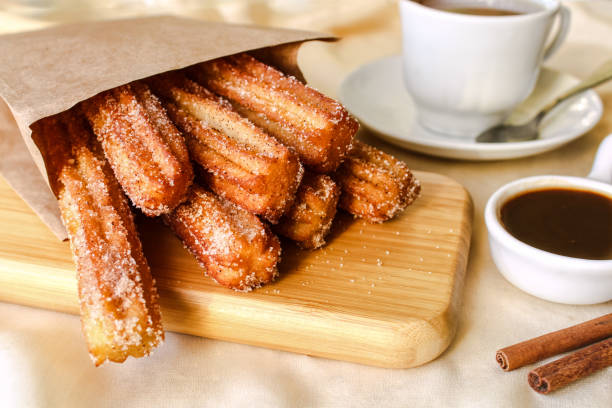 Churros with hot chocolate sauce, sugar and cinnamon.