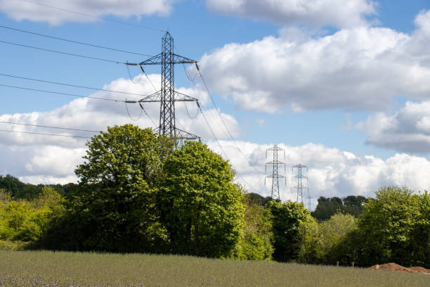 istock An electric pylon on a beautiful sunny summers day with white fluffy clouds in the sky. 2154874686