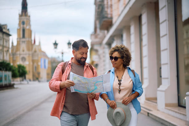 istock Smiling mature couple looking at map while sightseeing in the city. 2154878316
