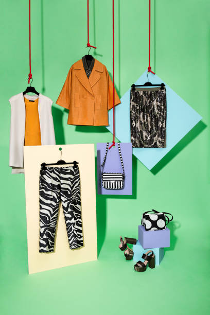 Fashionable women's clothing with personal accessories on multi colored background