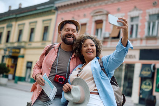 istock Happy mature couple taking selfie while sightseeing in the city. 2154879352