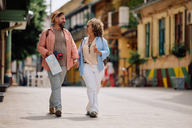 istock Happy mature couple talking while sightseeing through city on their vacation. 2154881401