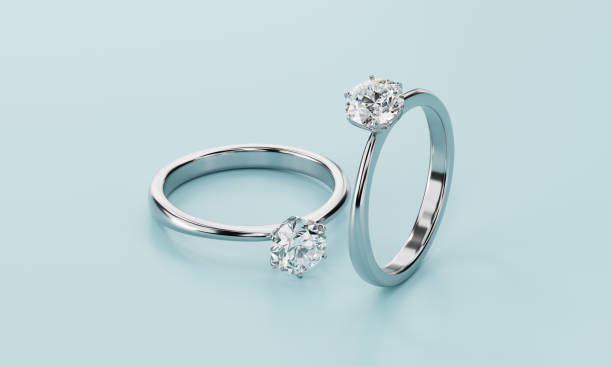 istock Couple diamond rings placed on pastel blue background 3d rendering 2154882730
