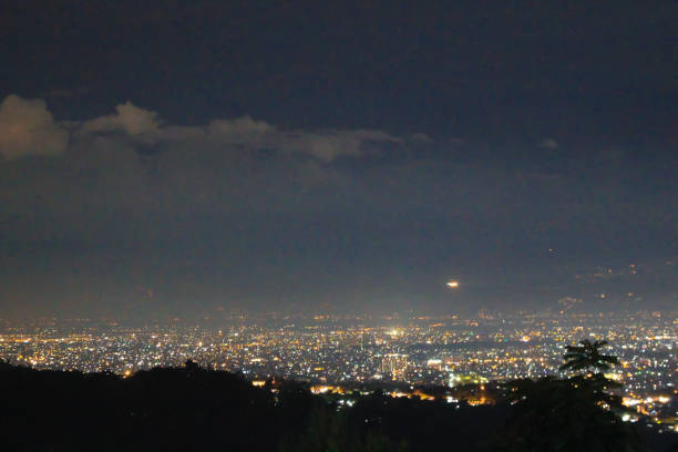 Night view of illuminated cityscape with Mt. Fuji in the distance