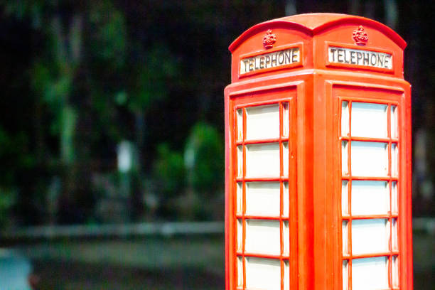 Souvenir red telephone box with blurred background, London phone booth - miniature souvenir,