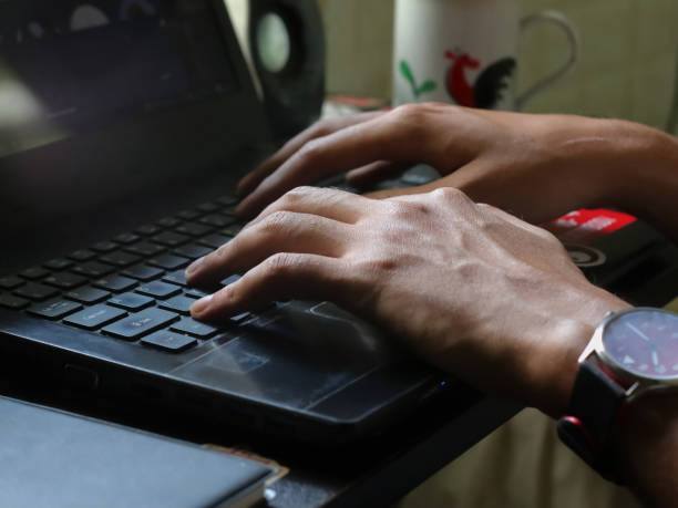 istock Man using smartphone and laptop on a desk 2154884638