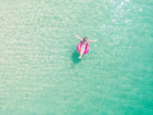 istock Woman Relaxing on Inflatable Float in Clear Water 2154886642