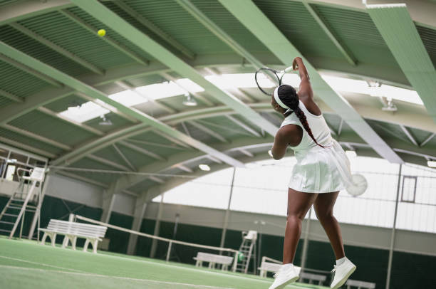 istock Female Tennis Player Hitting Ball 2154887113
